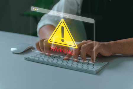 System hacked warning alert, Man using laptop with cyber attack network, virus, spyware, scam or Malicious software. Cyber security and cybercrime. Compromised information internet.の写真素材