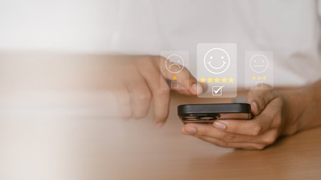 User give five star rating using a smartphone on the online application for the customer review satisfaction feedback survey idea, users rate their service experience.の写真素材
