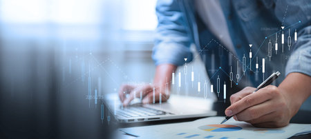 finance and investment, budget management concept. A businessman analysing a financial graph report,...