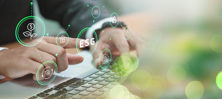 ESG environment social governance investment business concept. A businessman uses a computer to...