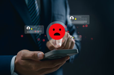 Poor Service Review with Red Unhappy Faces, One-Star Rating on Mobile Device. Representing Critical Feedback, Quality Issues, and Customer Concernsの写真素材