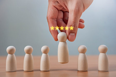 Leadership and Career Growth in HR Recruitment. A hand picks a wooden figure with five glowing...