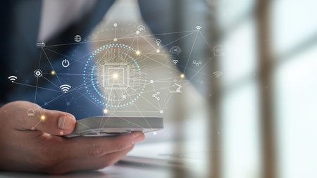 Industrial IoT and AI based technology concept with human hand using mobile device to manage smart...