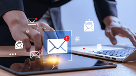 Email marketing workflow concept. professionals using mobile devices, and laptops with glowing message icons, representing campaign automation, outreach strategy, business communication strategy.の写真素材