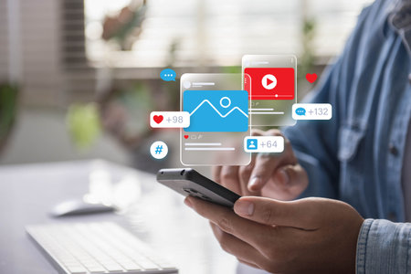 Social media marketing and online interaction concept. Person using smartphone to engage with social...