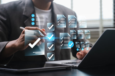 Digital Document Management, businessman checklist software for digital files and task tracking on laptop, showing workflow optimization, paperless planning, and productivity with cloud technologyの写真素材