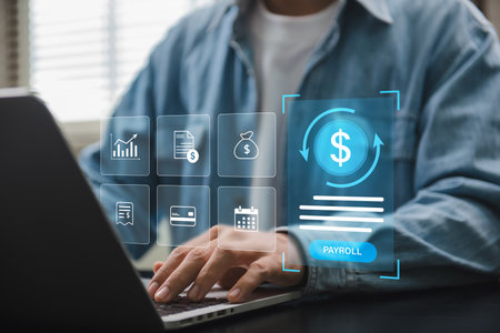 Payroll digital management system showing person operating financial software on laptop for salary calculation, tax payment and business accounting in digital fintech company setupの写真素材