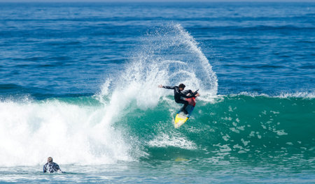 Bodyboarder in action on the ocean wave on a sunny day.