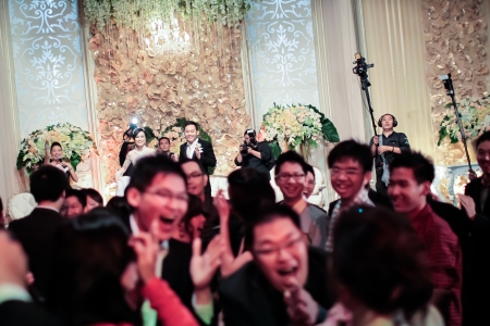 INDONESIA, JAKARTA, 9th March 2012. Bride and groom smiling after throwing their bouquet to the guests.のeditorial素材