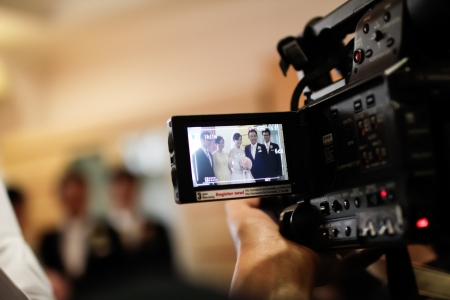 INDONESIA, JAKARTA, 9th March 2012. Video camera recording a wedding ceremony in the bride's house.のeditorial素材