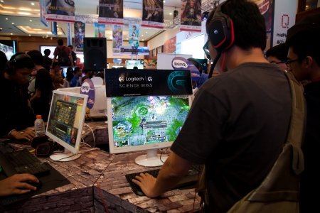 Jakarta, Indonesia, 8th September 2013: Several visitors playing video games on one of the stands at Indo Game Show 2013 event at Jakarta Convention Center, Jakarta, Indonesia.のeditorial素材