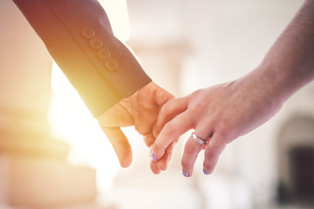 Hand in hand. Couple in love showing affection on summer day.