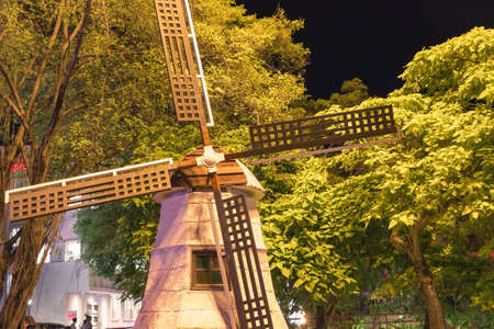 Old Dutch wind mill during night time with green trees.の写真素材
