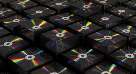A close-up shot of a collection of CDs, arranged in a grid-like pattern, with light reflecting off the surfaces.の素材