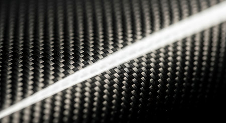 Black carbon fiber close-up macro shot. Industrial background of carbon fiber.の素材