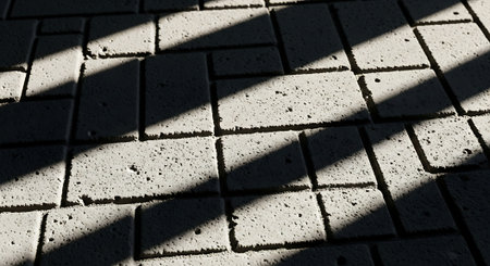 The shadow of the sun on the paving slabs. Abstract background.の素材