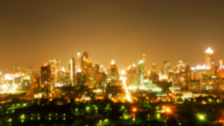 Defocus and blur image of building and natural park at night. Blurred building and city at night....