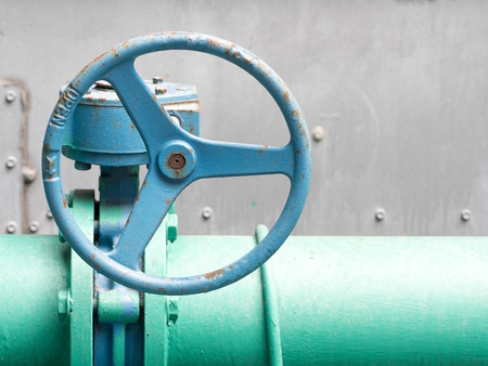 Blue old valve and old green pipe. Industrial water valve.の写真素材