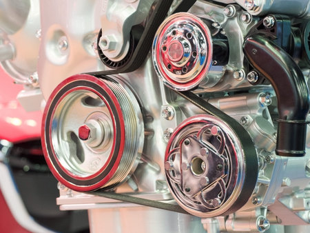 Closeup of modern automobile motor car engine part focus on pulley with belt.