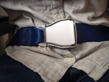Passenger wearing seat belt in Airplane to save life while flying in sky. Safety and travel concept.の写真素材