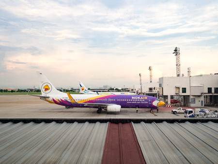 BANGKOK, THAILAND JULY 24, 2016: Airplane Thai Nokair parking on Bangkok International Airport (Don Muang) Bangkok. Engineers are maintain the engine of the aircraft,Thailand. July 24 2016.のeditorial素材