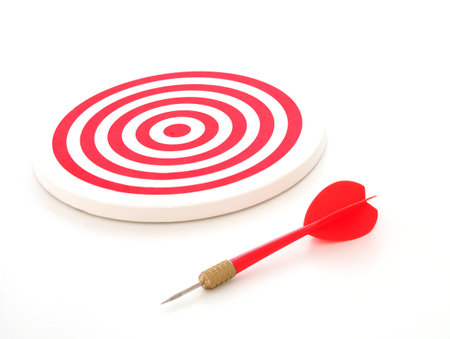 Red bullseye dart arrow and red dartboard isolated on white background.