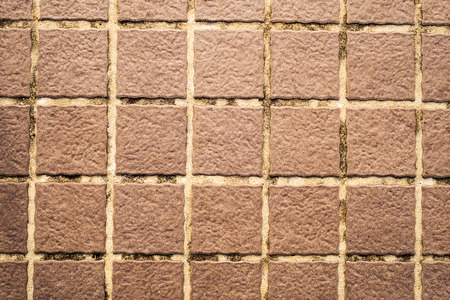 Old brown wall tiles backgroundの写真素材