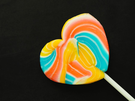 colorful sweet heart candy blue green yellow pink on black background.の写真素材