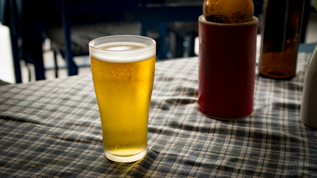 Glass of cold light beer on table freshness and refreshing beverages.の写真素材
