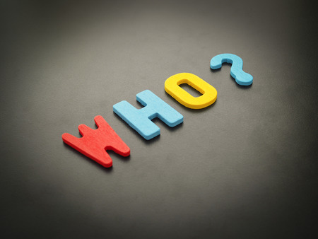 "Who" word from wood. Colorful of wooden Who question mark on black background.の写真素材