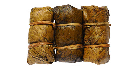 Bananas with sticky rice and black bean wrapped in banana leaf (Khao Tom Mat or Khao Tom Pad). Thai traditional dessert.の写真素材