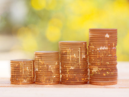 Double exposure of city and coin stack for business finance and banking concept. Golden color coin...