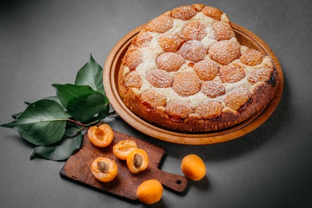 Homemade cheesecake with apricots on a gray backgroundの写真素材