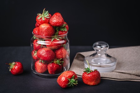 Ripe juicy strawberries in a glass on a dark backgroundの写真素材