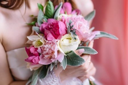 Beautiful wedding bouquet in hands of the bride, selective focusの写真素材