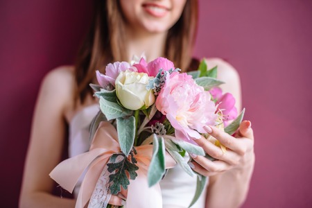 Beautiful wedding bouquet in hands of the bride, selective focusの写真素材