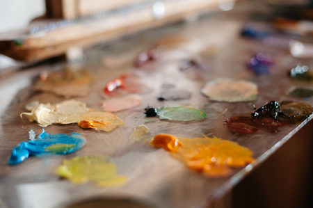 Palette of oil paints on glass, selective focus, backgroundの写真素材
