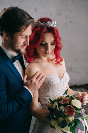 portrait of young happy newlyweds in a loft style room, close-upの写真素材