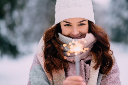 young happy woman holding burning sparklersの写真素材