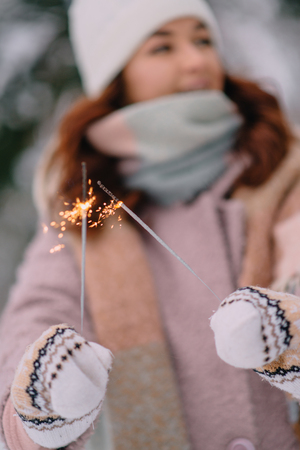 burning sparklers in womans hands, selective focusの写真素材