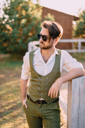 portrait stylish man on background of ranchの写真素材