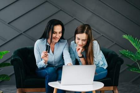 Two girlfriends shop online, black friday concept