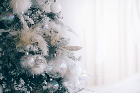 Close-up xmas tree decorated with balls in silver color on a white backgroundの写真素材