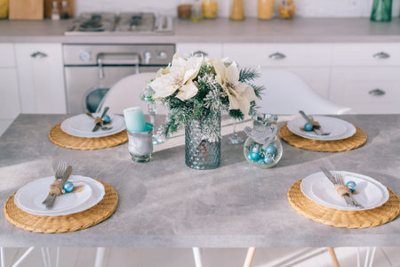 Close-up, festive Christmas table setting in a bright cozy kitchen