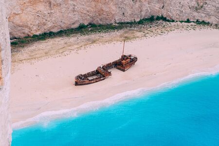 An old rusted ship, wrecked, lies on the seashore. Navagio Bay Shipwreck Beach Greece, Zakynthosの写真素材