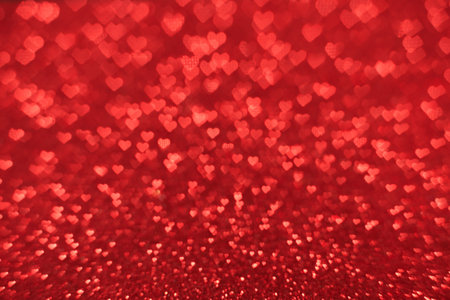 The bokeh texture in the form of many small hearts on a red background. Valentine's day concept.