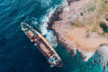 Top view of a ship stranded near the shore, drone shot.の写真素材