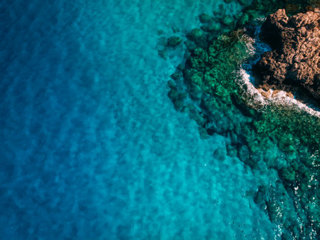 Overhead Rocky sea shore with crystal clear blue water, Cyprusの写真素材