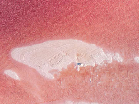 The surface of a pink lake with islands of salt. Top-down view.の写真素材
