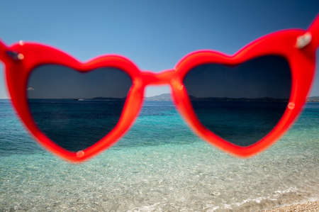 View through sunglasses to beach on sunny day. Close up.の写真素材